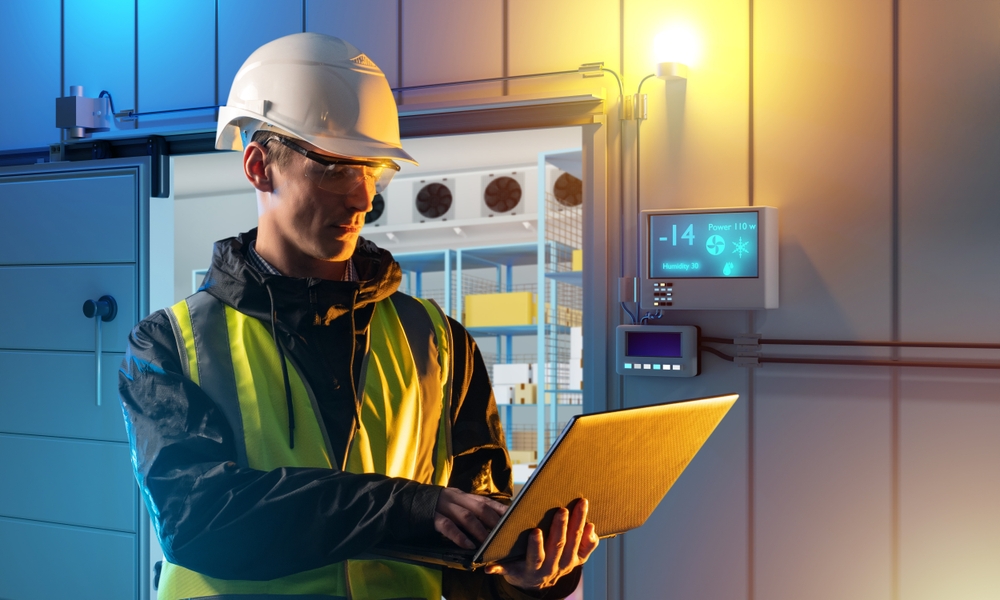 Man,is,industrialist.,guy,near,refrigerator.,industrialist,with,laptop.,setting